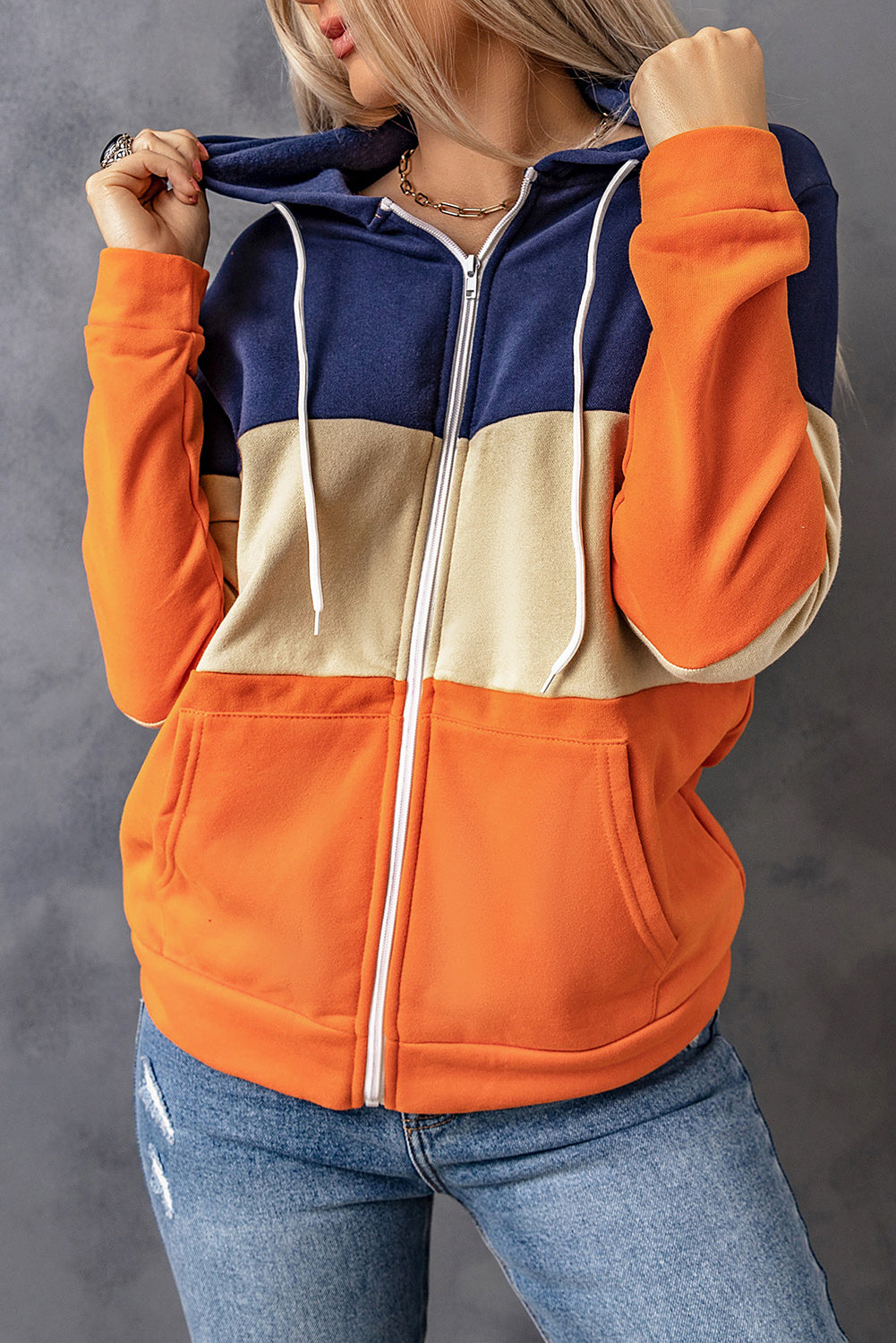 Black zip front hoodie featuring color block splicing and drawstring hood, perfect for casual wear.