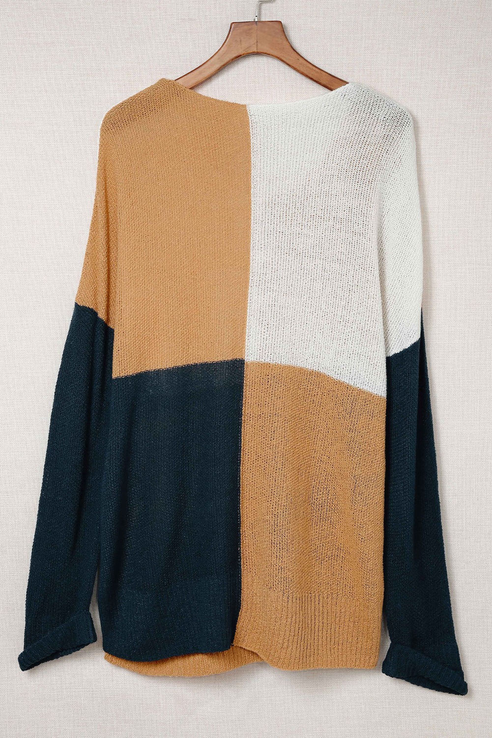 A stylish blue color block plus size sweater featuring side slits, designed for comfort and a chic look.