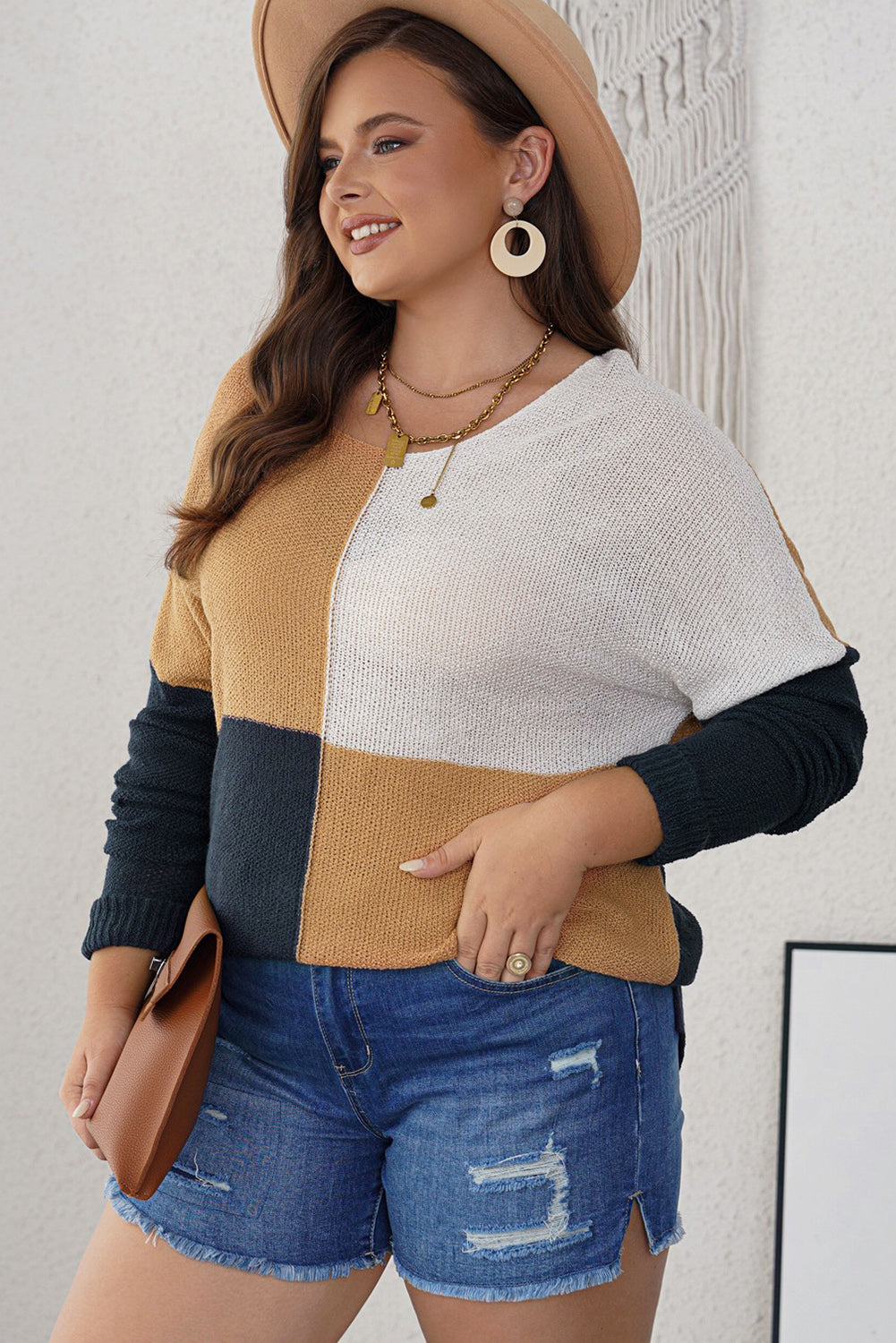 A stylish blue color block plus size sweater featuring side slits, designed for comfort and a chic look.