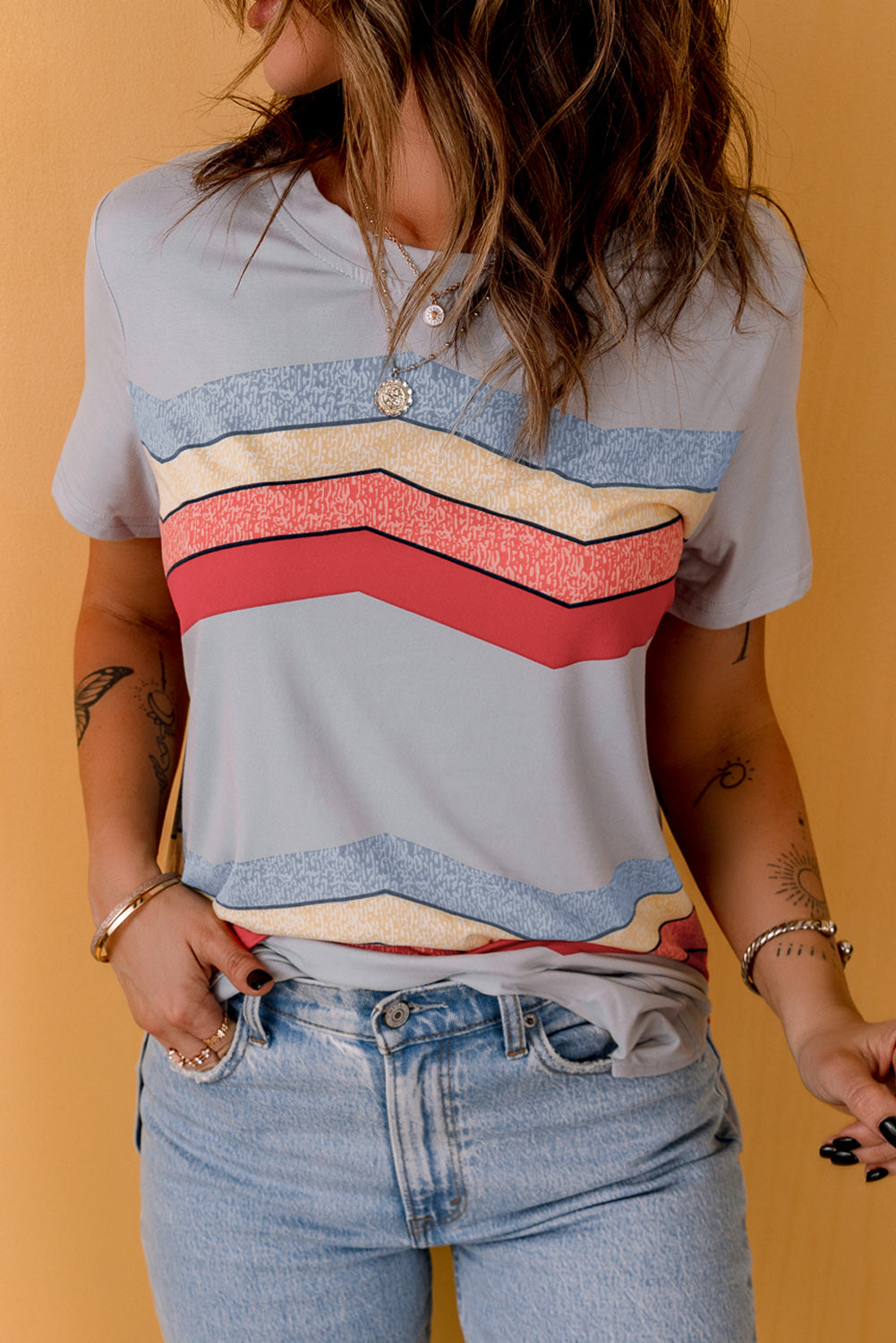 Blue short sleeve tee featuring colorful wavy stripes print, perfect for casual wear.