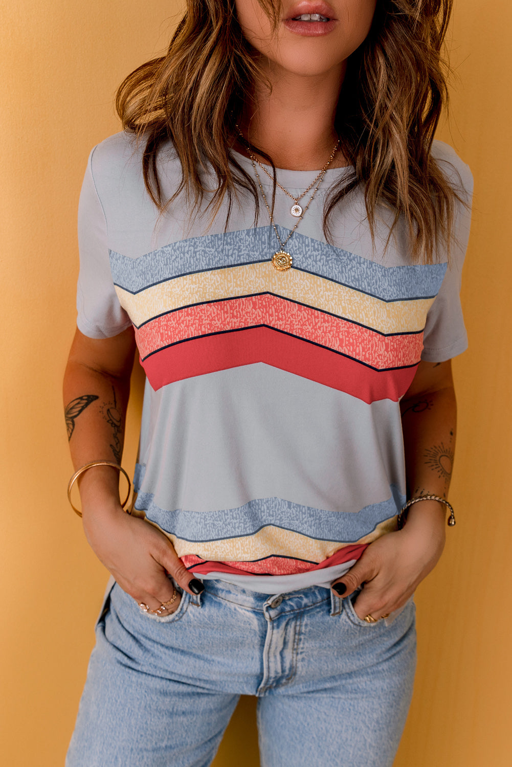 Blue short sleeve tee featuring colorful wavy stripes print, perfect for casual wear.