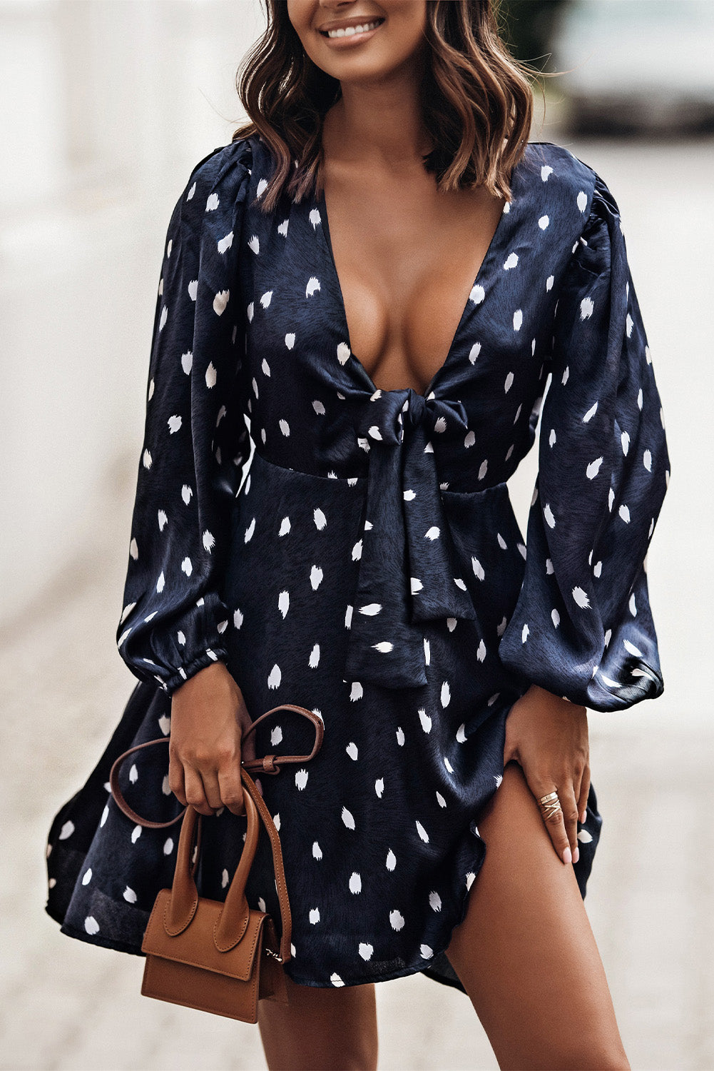 A stylish blue A-line dress featuring a deep V neck, balloon sleeves, and a knotted front with a polka dot print, perfect for various occasions.