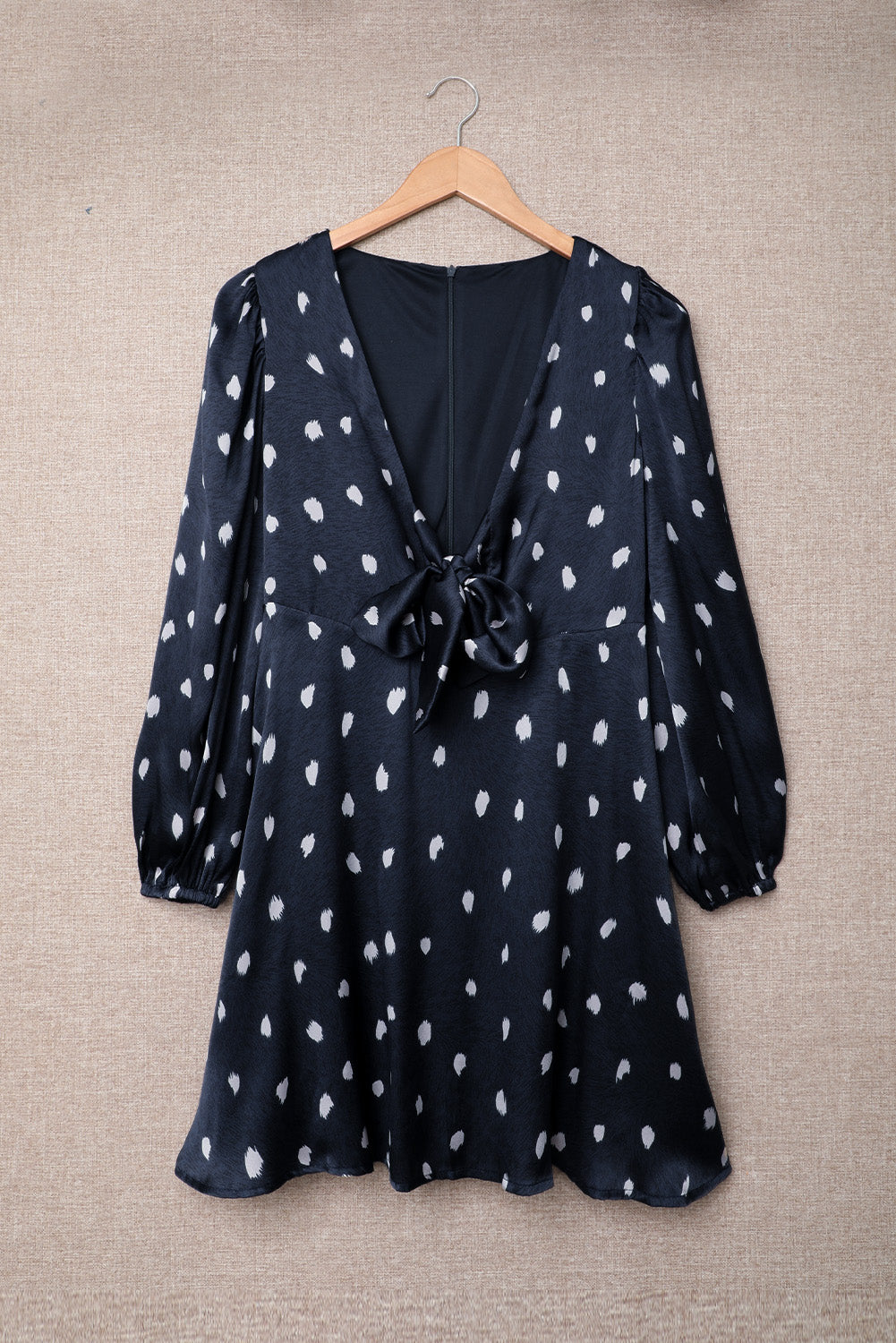 A stylish blue A-line dress featuring a deep V neck, balloon sleeves, and a knotted front with a polka dot print, perfect for various occasions.