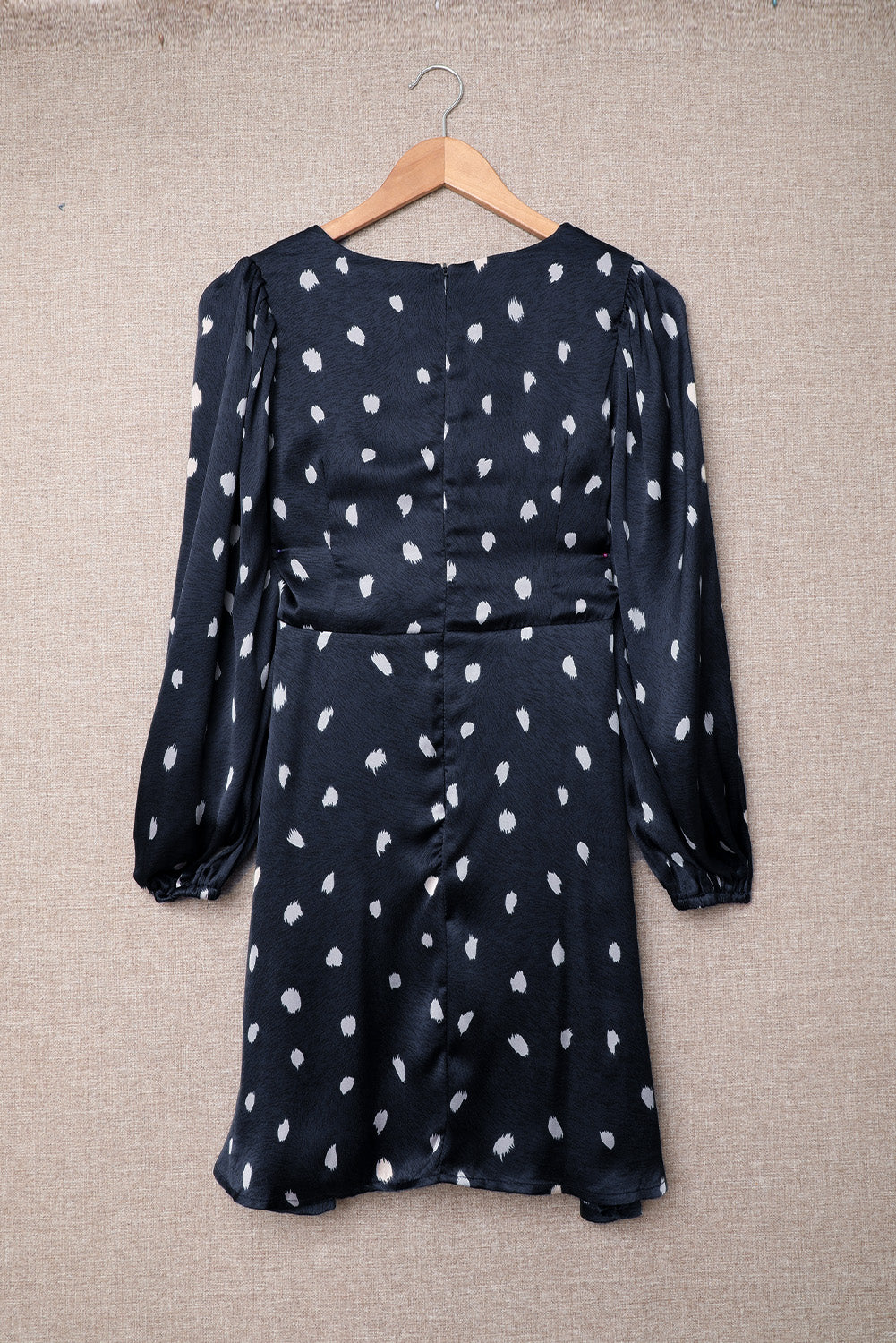 A stylish blue A-line dress featuring a deep V neck, balloon sleeves, and a knotted front with a polka dot print, perfect for various occasions.