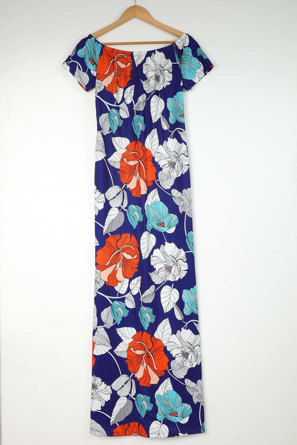 A beautiful plus size maxi dress featuring a blue green floral print and an off-the-shoulder design, perfect for elegant occasions.