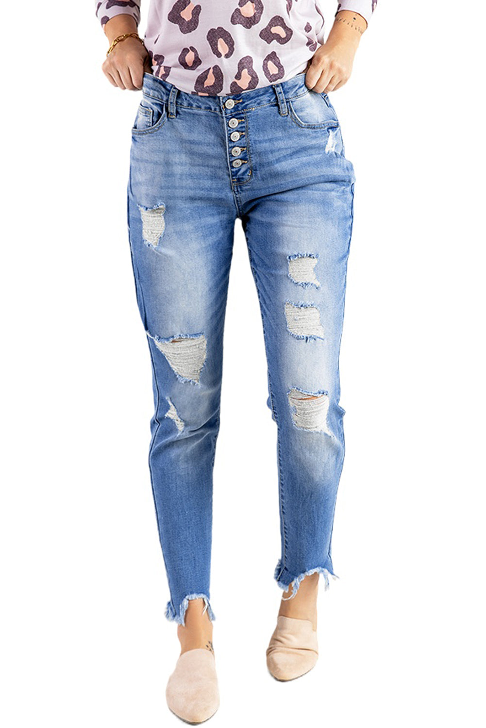 Blue high rise skinny jeans with button front and frayed ankle hem, showcasing a medium wash and distressed details.