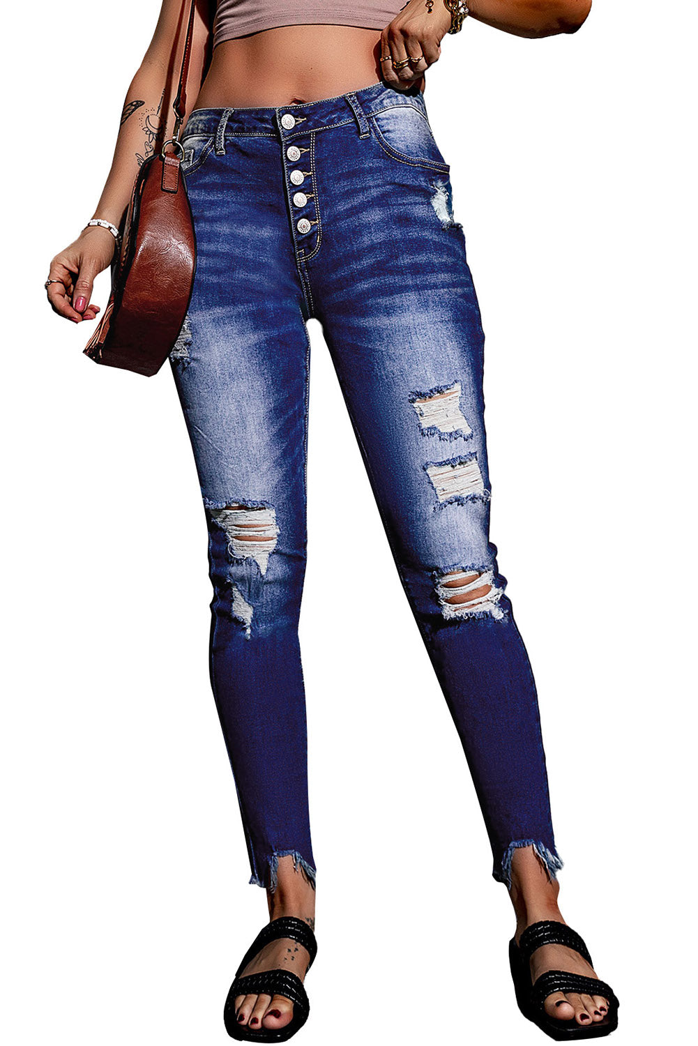 Blue high rise skinny jeans with button front and frayed ankle hem, showcasing a medium wash and distressed details.