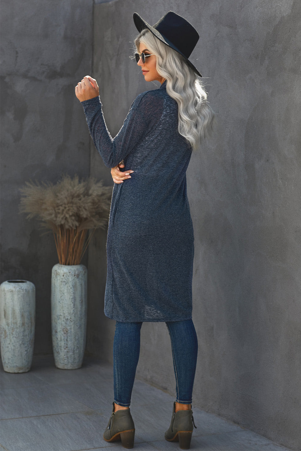 A stylish blue slouchy pocketed knit longline cardigan displayed on a mannequin, showcasing its relaxed fit and soft texture.