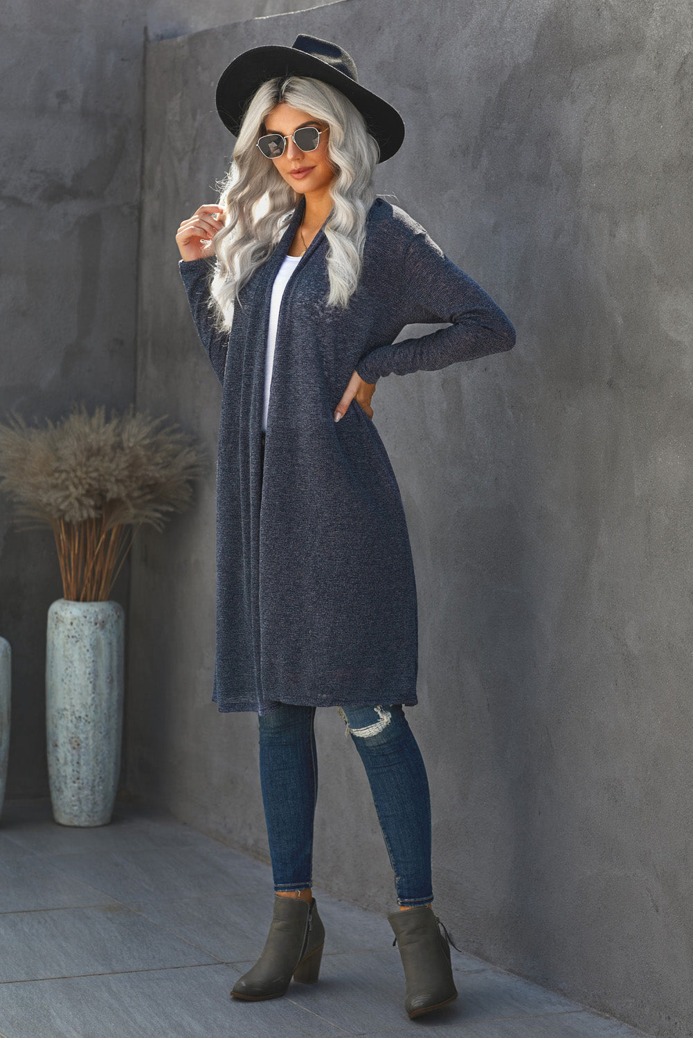 A stylish blue slouchy pocketed knit longline cardigan displayed on a mannequin, showcasing its relaxed fit and soft texture.