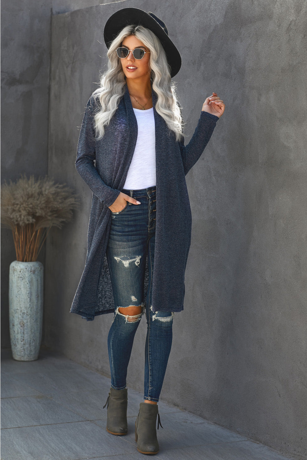 A stylish blue slouchy pocketed knit longline cardigan displayed on a mannequin, showcasing its relaxed fit and soft texture.