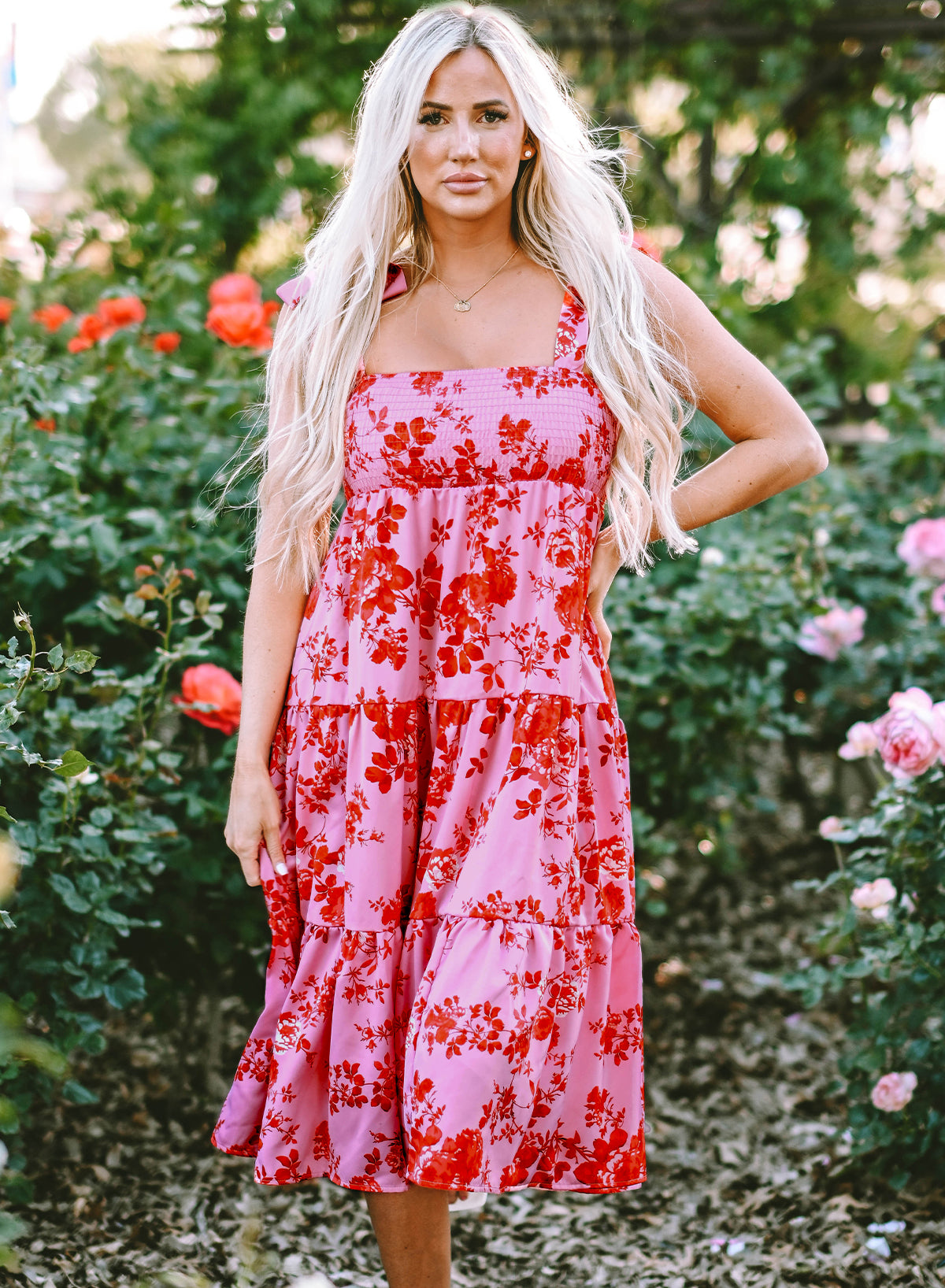 A beautiful blue tiered floral dress with tie shoulder straps, perfect for summer occasions.