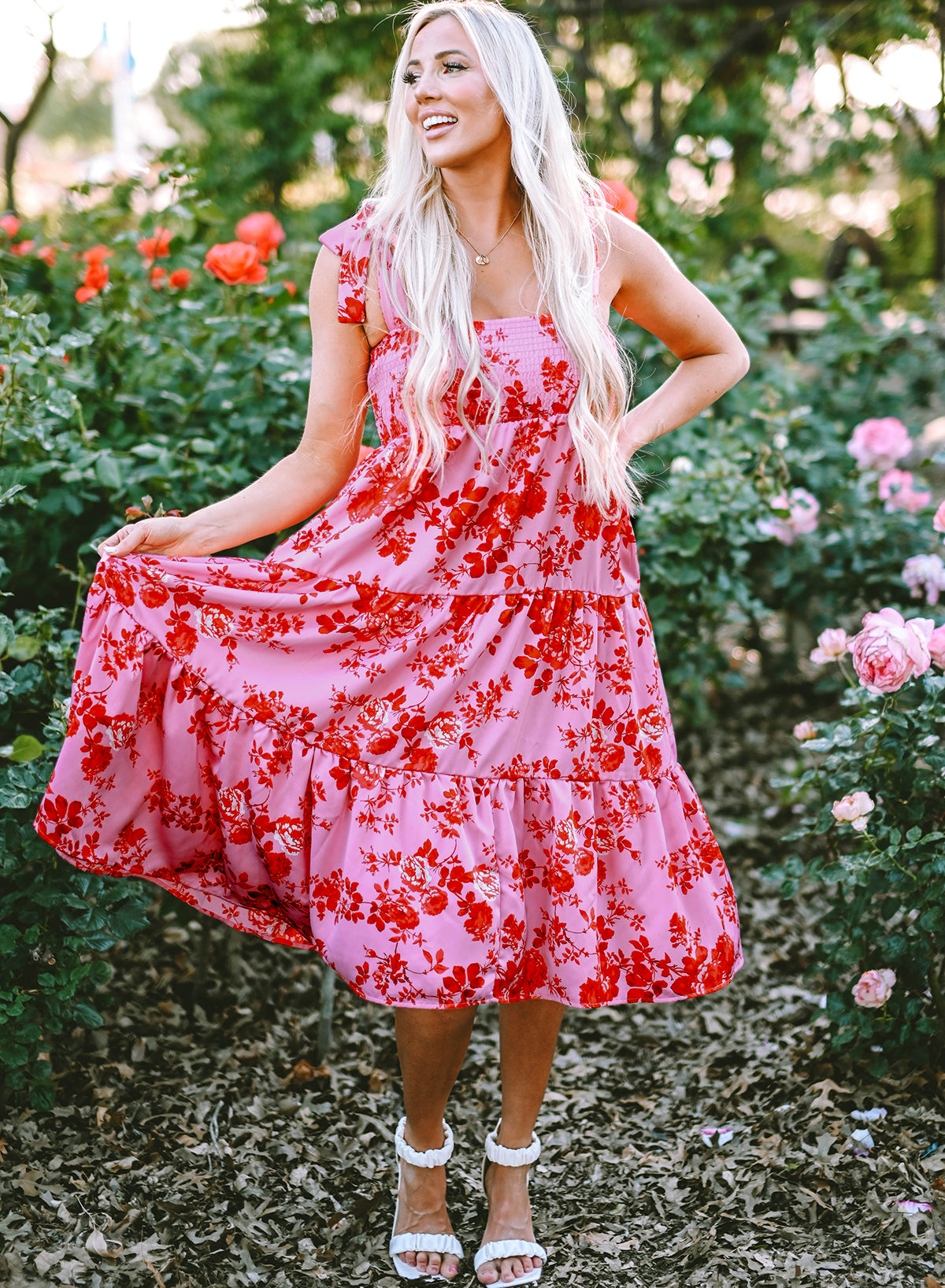 A beautiful blue tiered floral dress with tie shoulder straps, perfect for summer occasions.