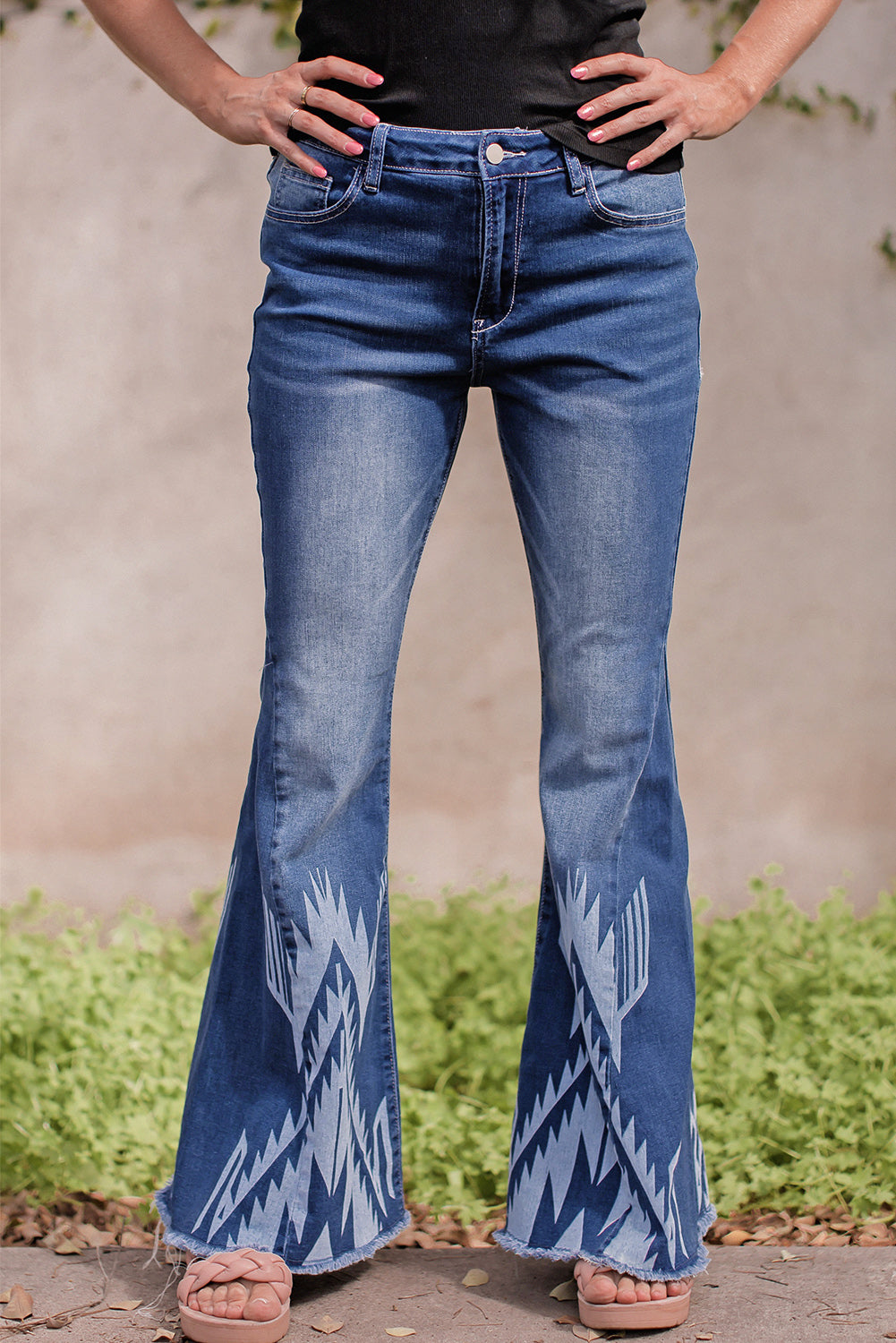 A pair of Blue Western Pattern High Rise Flare Jeans displayed on a white background, showcasing the flared design and high-rise waist.