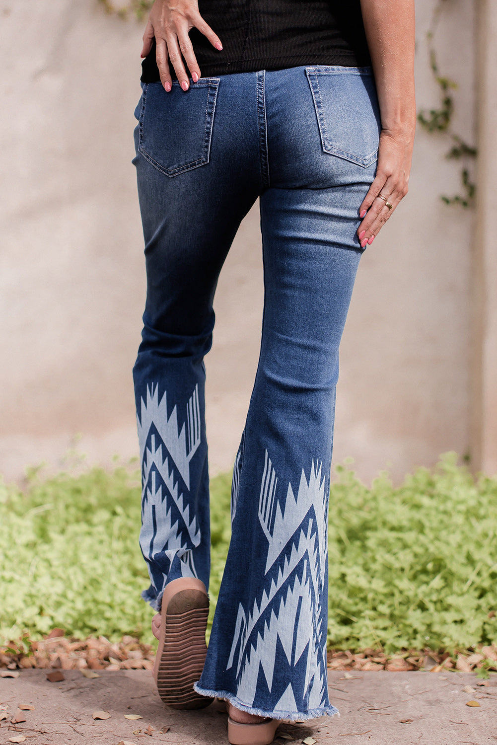 A pair of Blue Western Pattern High Rise Flare Jeans displayed on a white background, showcasing the flared design and high-rise waist.