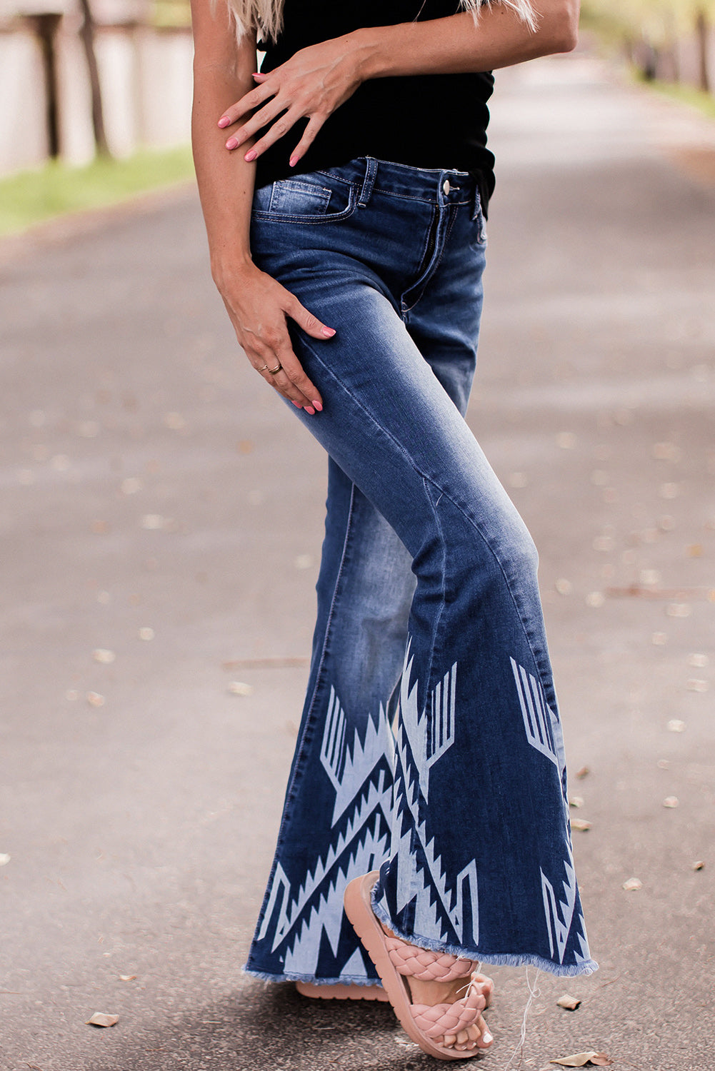 A pair of Blue Western Pattern High Rise Flare Jeans displayed on a white background, showcasing the flared design and high-rise waist.