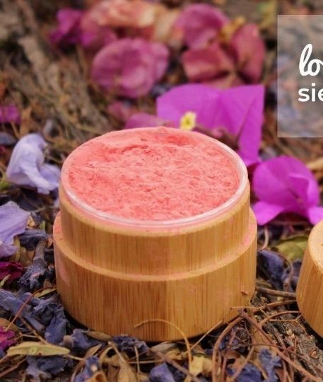 A bamboo container filled with blush loose powder, showcasing its eco-friendly design and natural ingredients.