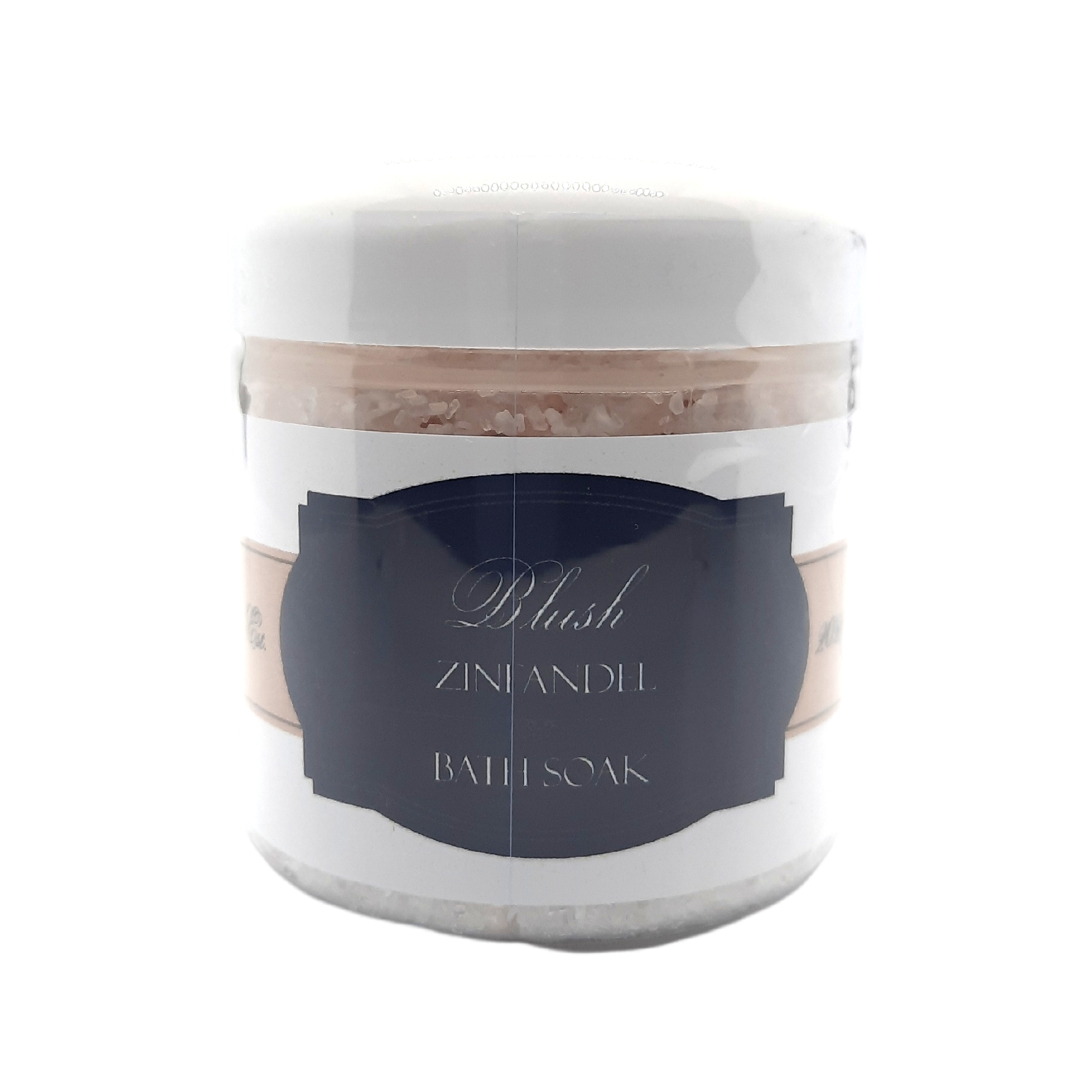 A luxurious Blush Zinfandel Bath Soak in a clear jar, surrounded by natural ingredients like Dead Sea salt and Epsom salt, with a calming pink hue.