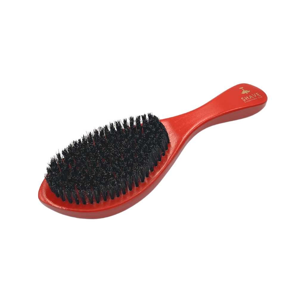 Boar Bristle Hair Brush with Handle in red and black, showcasing natural bristles and ergonomic design for effective grooming.