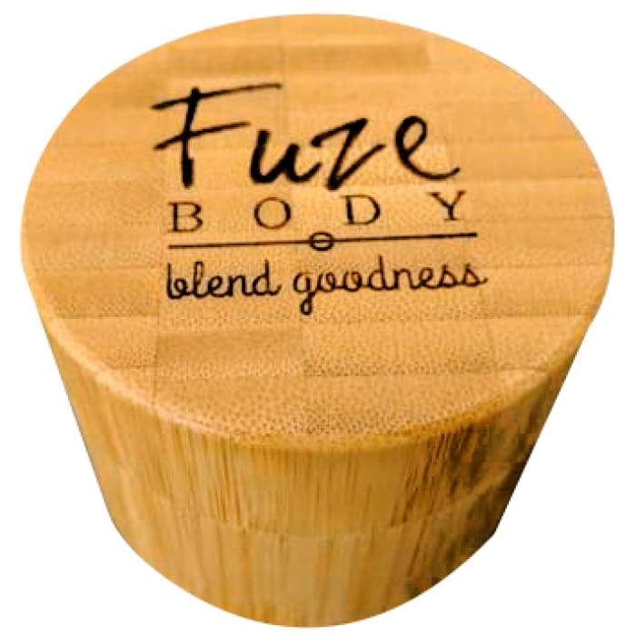 A jar of Body Butter - Breathe Clear in a beautifully engraved bamboo container, showcasing its light and fluffy texture.