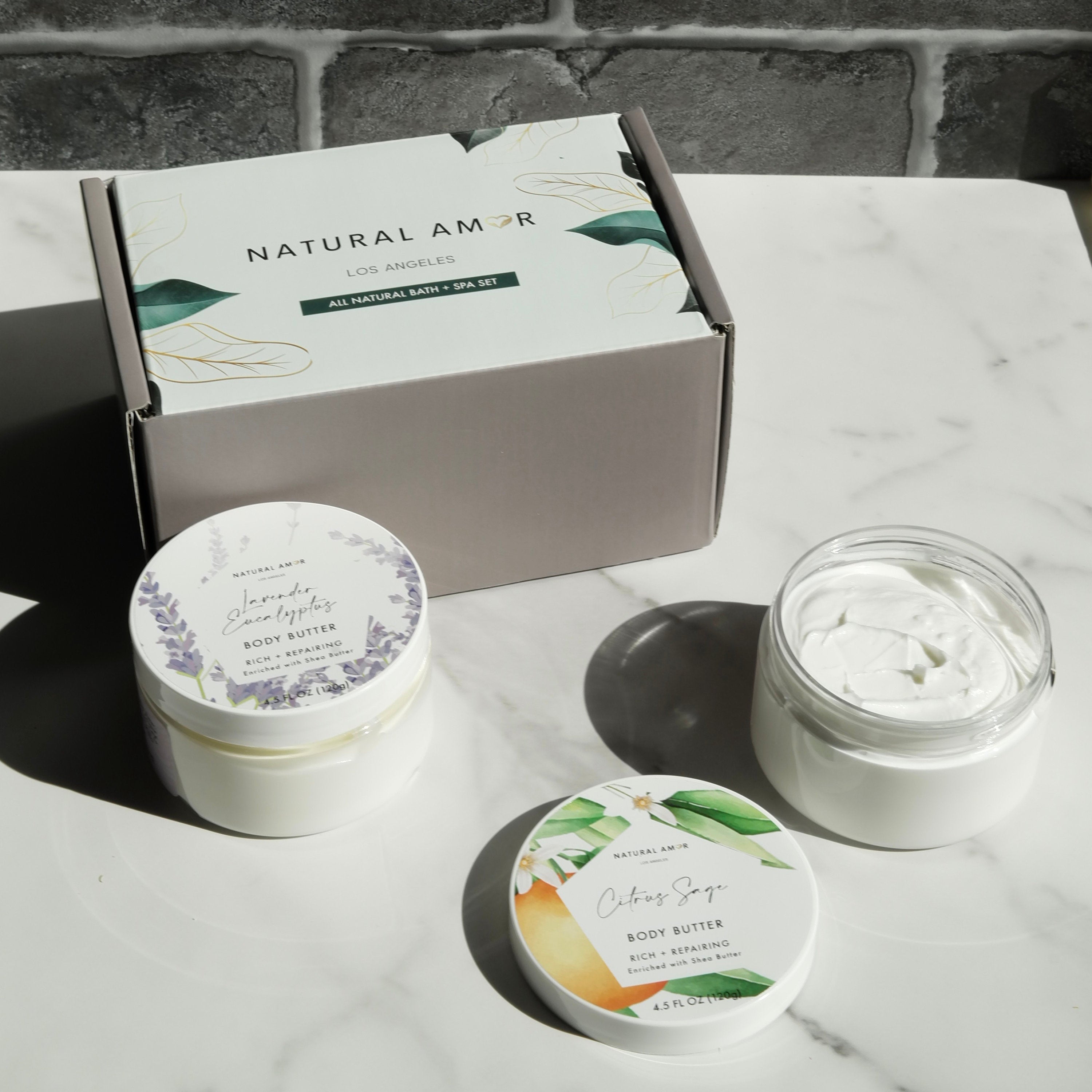 Body Butter Trio Gift Set featuring three 4oz jars in a beautifully designed gift box, showcasing Lavender Eucalyptus, Citrus Sage, and Rose Cedarwood scents.