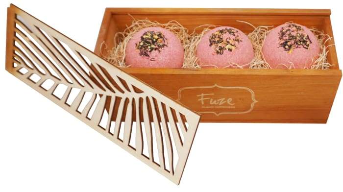 Bomb Cores gift box featuring three colorful bath bombs and a soap ball, elegantly packaged in a handcrafted wooden box.