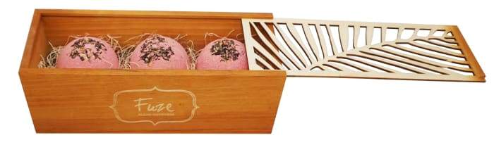 Bomb Cores gift box featuring three colorful bath bombs and a soap ball, elegantly packaged in a handcrafted wooden box.