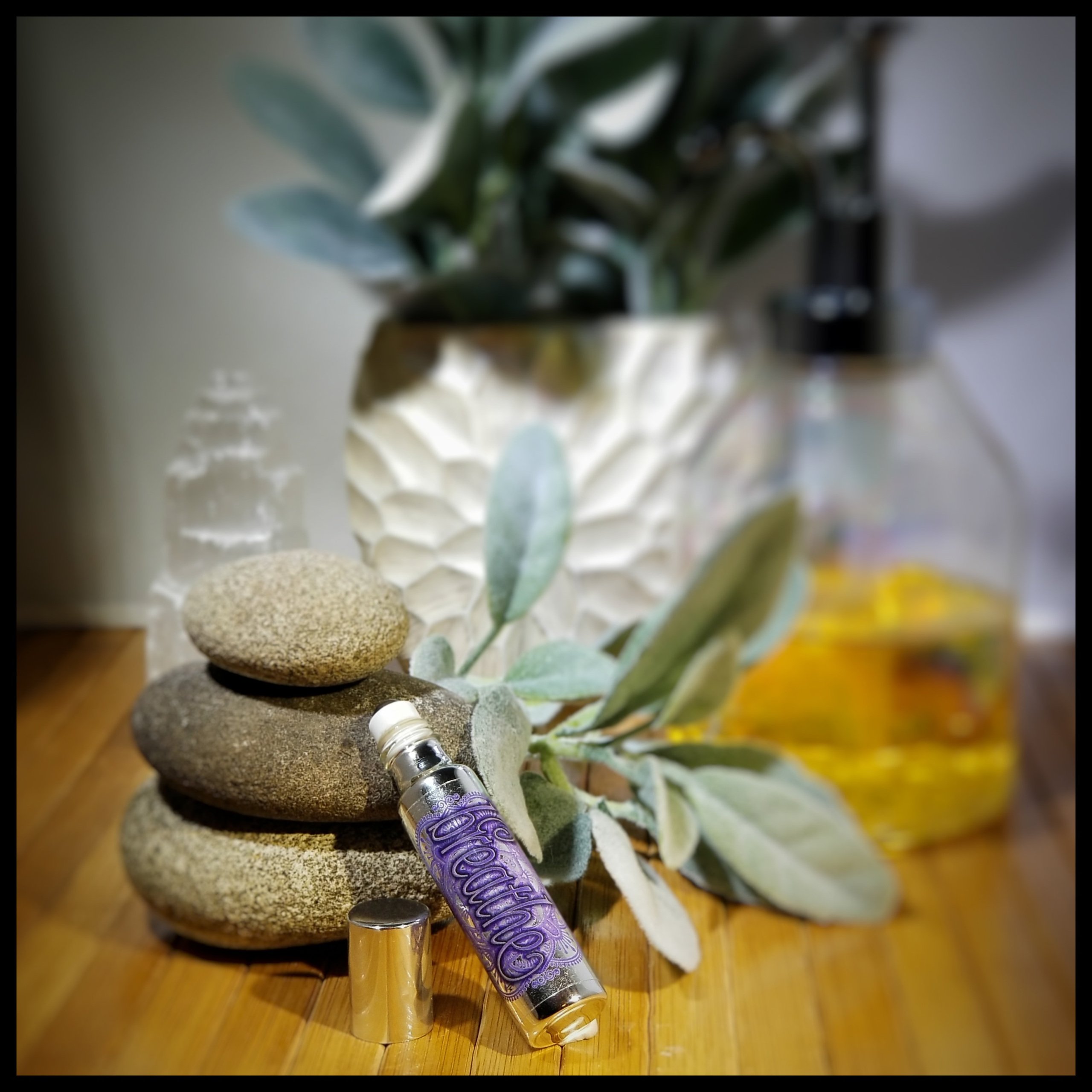 Breathe Essential Oil Roll-On in a stylish metallic glass bottle with a refreshing peppermint scent.