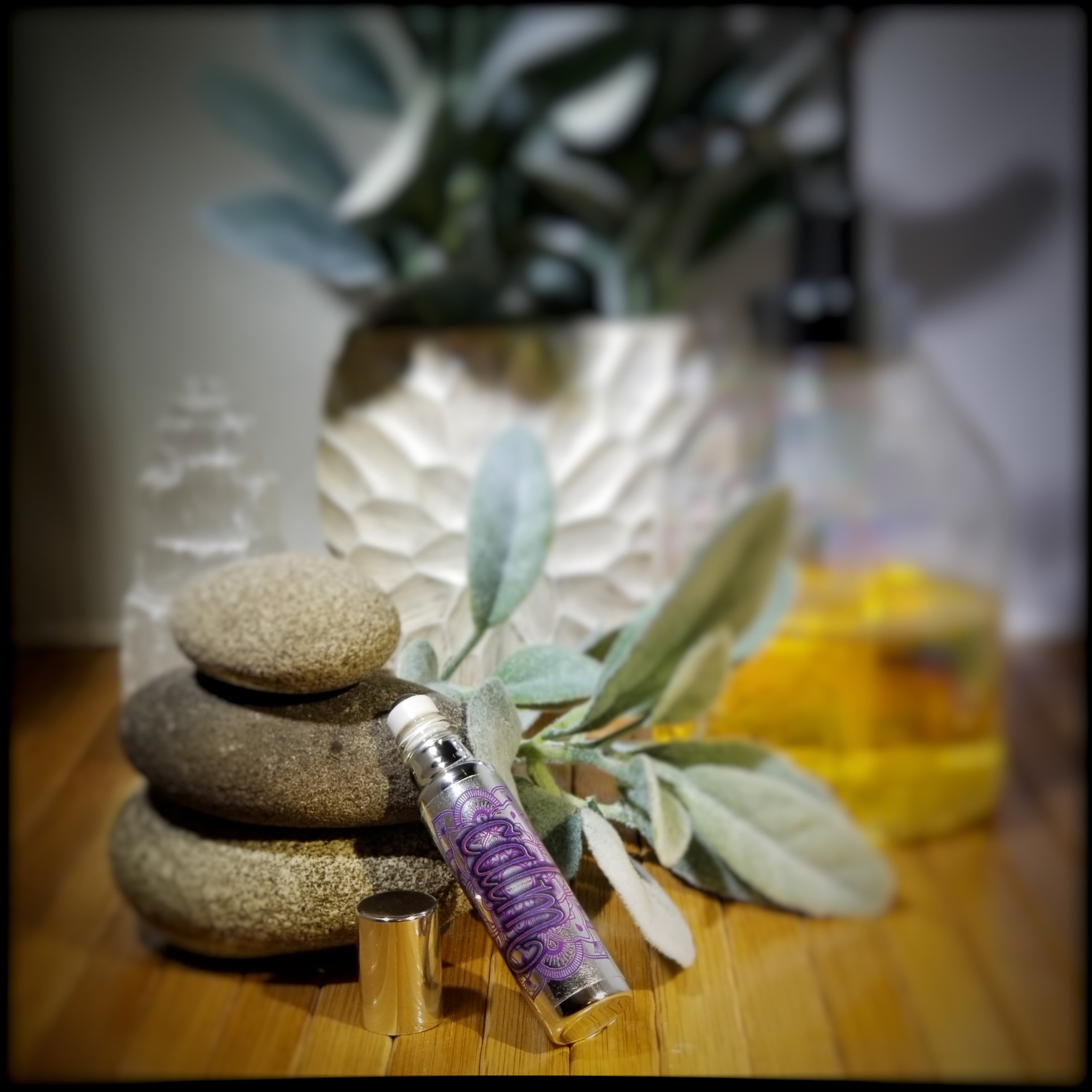 Breathe Essential Oil Roll-On in a stylish metallic glass bottle with a refreshing peppermint scent.