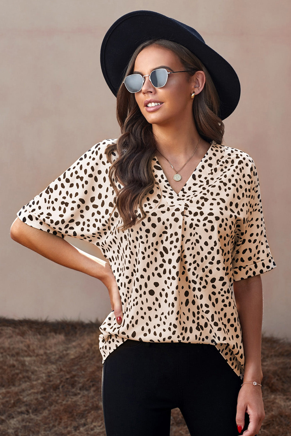 Brown animal print V-neck tunic top with rolled sleeves, showcasing a stylish design and comfortable fit.