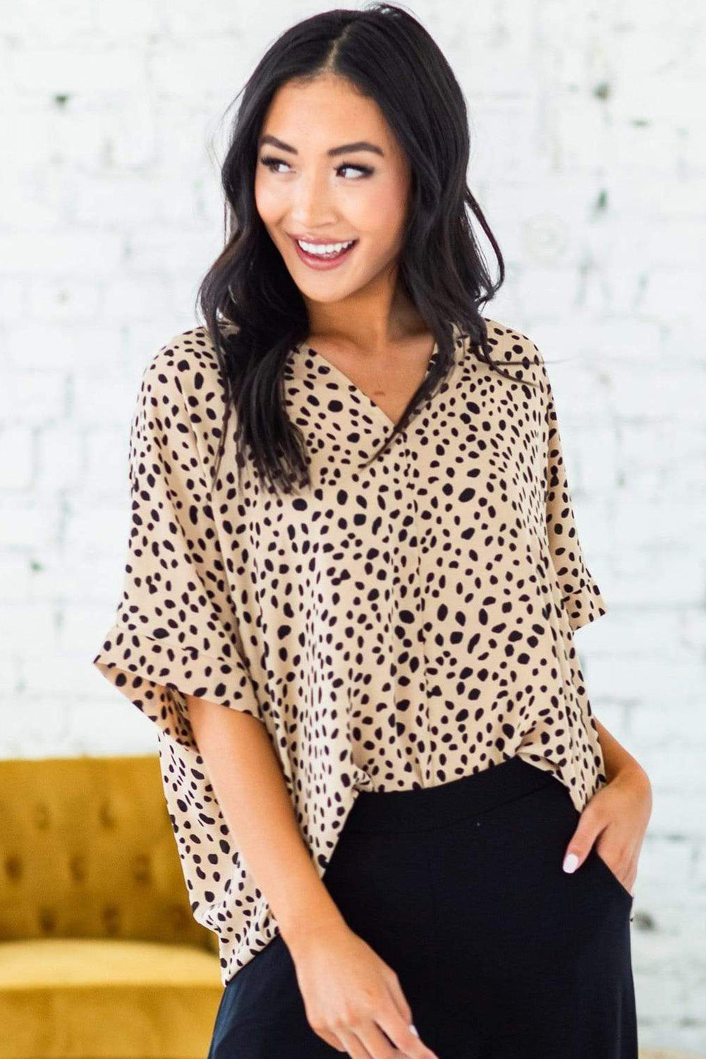 Brown animal print V-neck tunic top with rolled sleeves, showcasing a stylish design and comfortable fit.