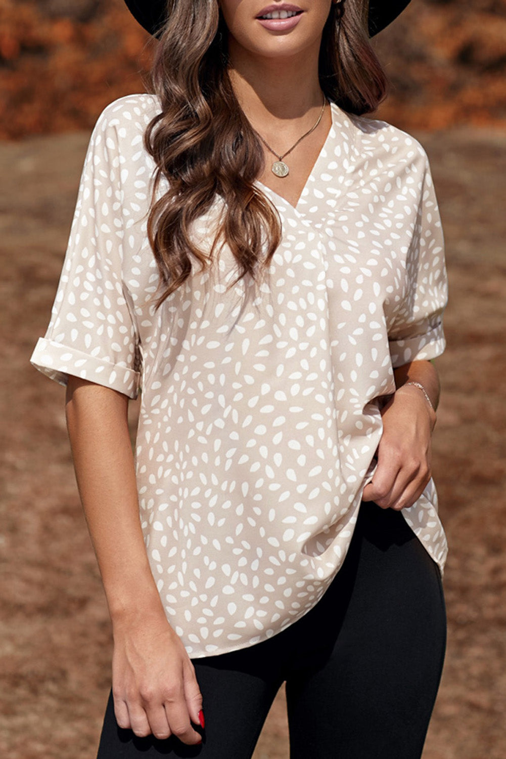 Brown animal print V-neck tunic top with rolled sleeves, showcasing a stylish design and comfortable fit.