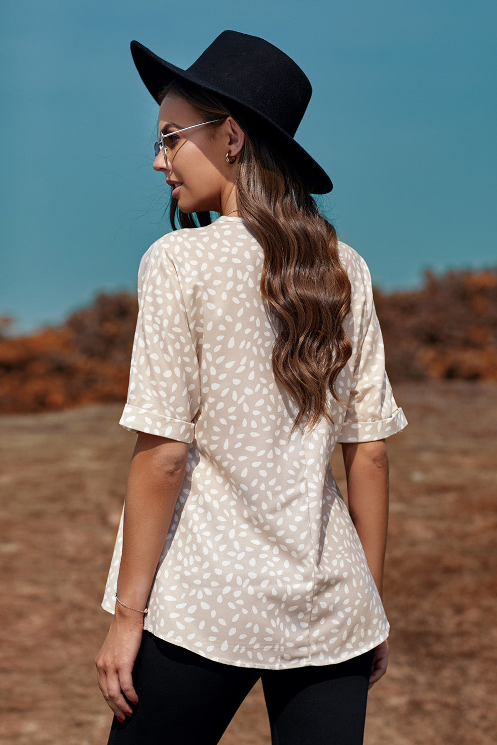 Brown animal print V-neck tunic top with rolled sleeves, showcasing a stylish design and comfortable fit.