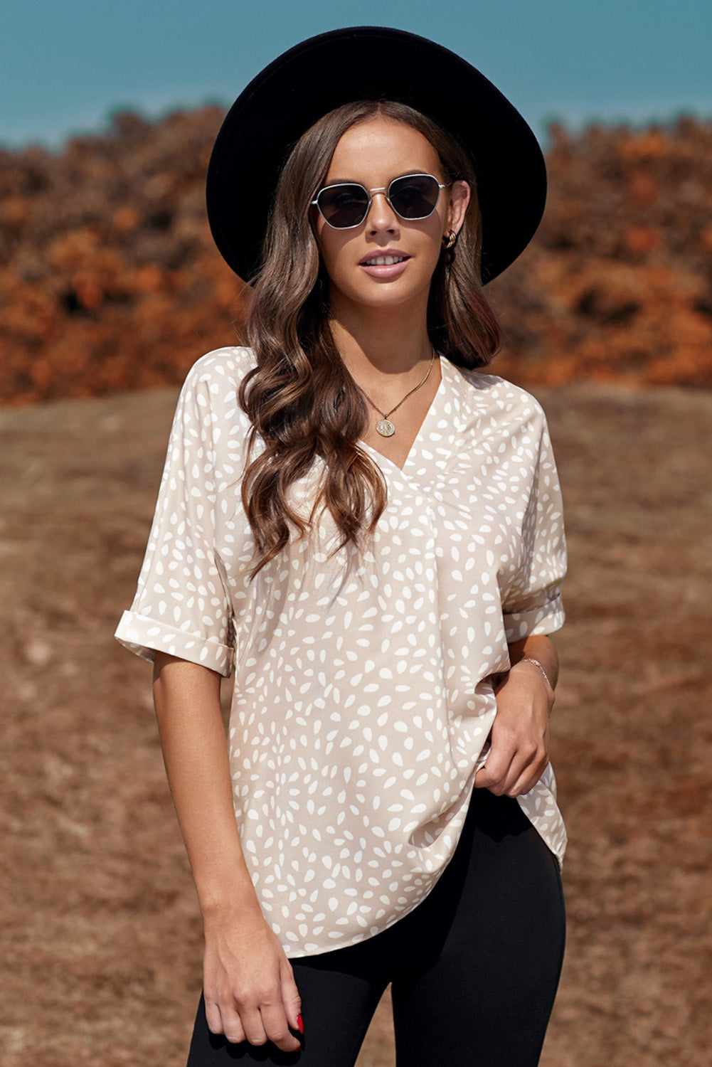 Brown animal print V-neck tunic top with rolled sleeves, showcasing a stylish design and comfortable fit.