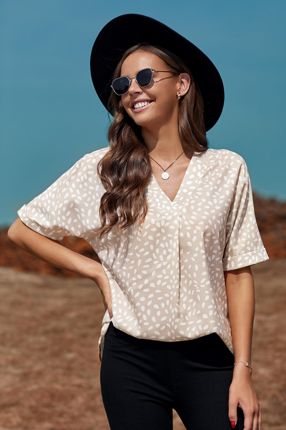 Brown animal print V-neck tunic top with rolled sleeves, showcasing a stylish design and comfortable fit.