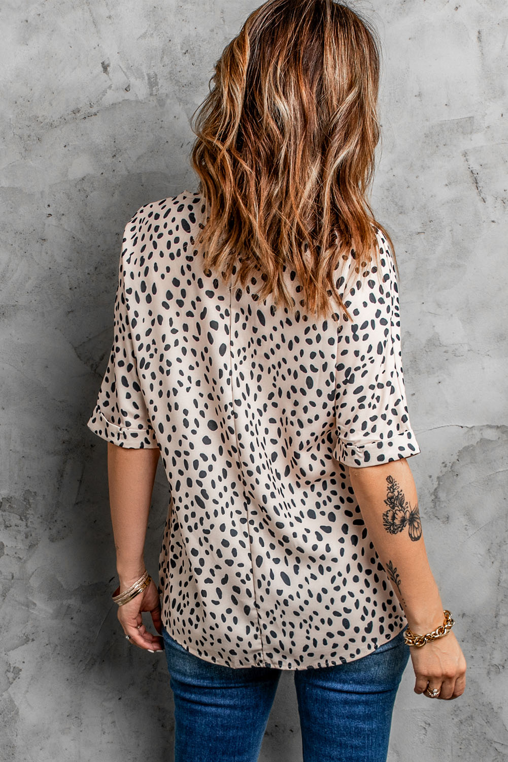 Brown animal print V-neck tunic top with rolled sleeves, showcasing a stylish design and comfortable fit.