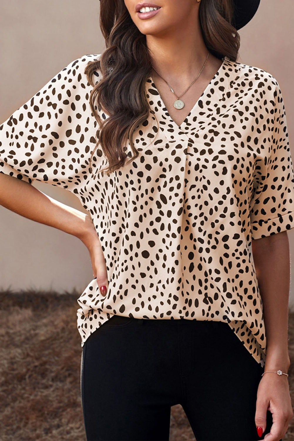 Brown animal print V-neck tunic top with rolled sleeves, showcasing a stylish design and comfortable fit.