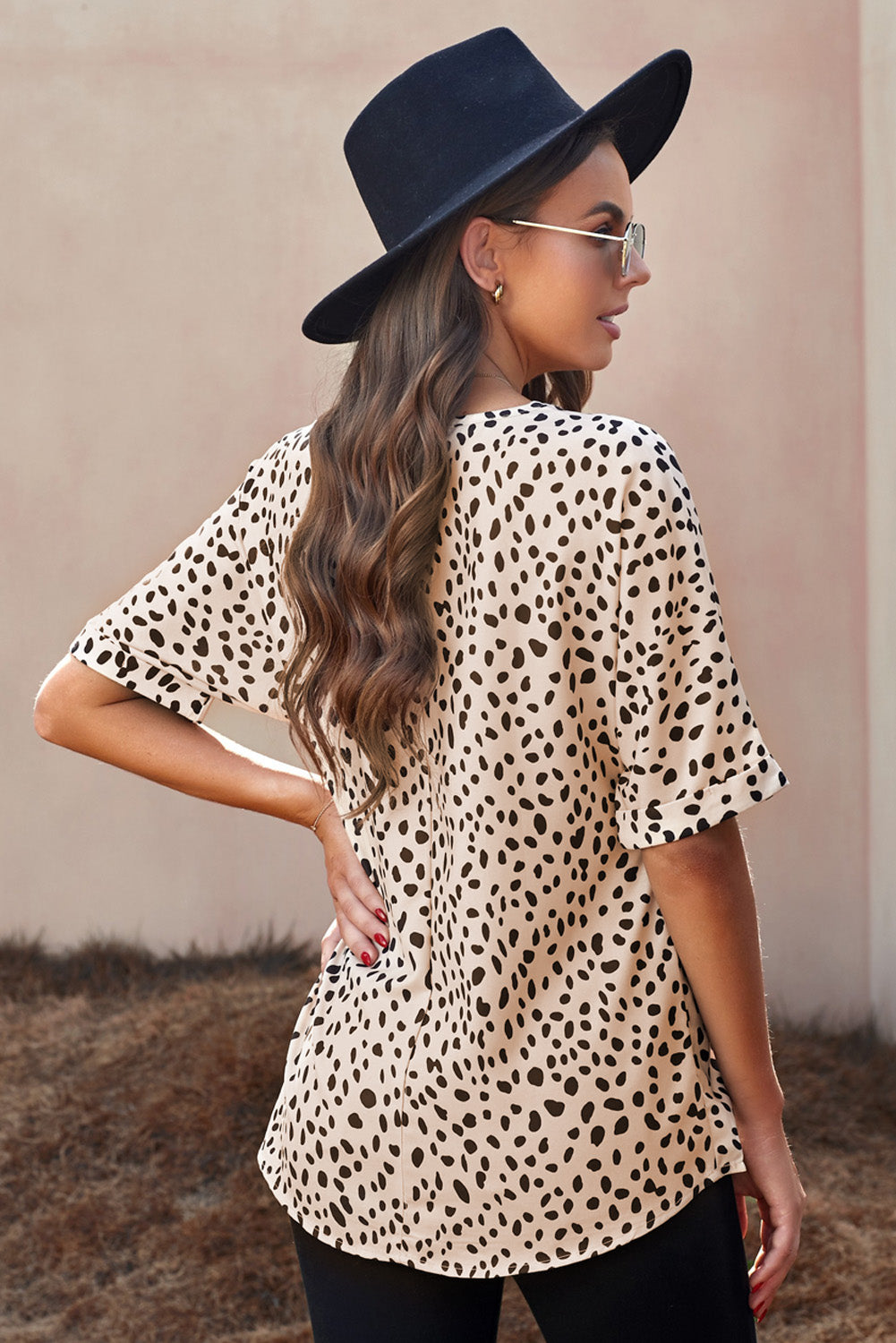 Brown animal print V-neck tunic top with rolled sleeves, showcasing a stylish design and comfortable fit.