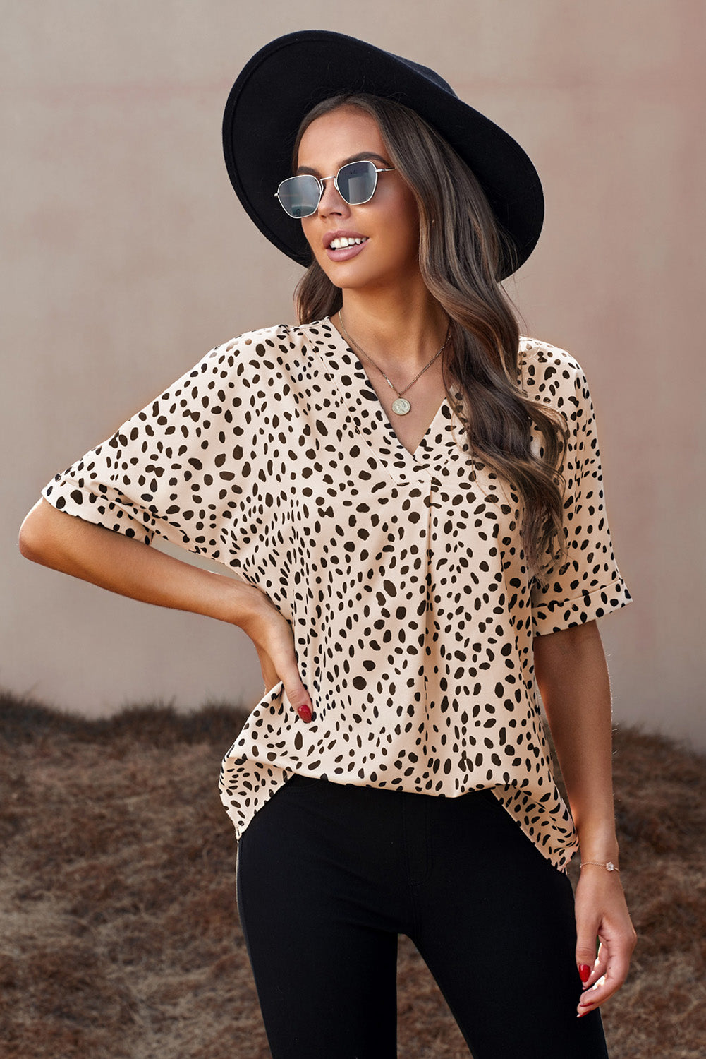 Brown animal print V-neck tunic top with rolled sleeves, showcasing a stylish design and comfortable fit.