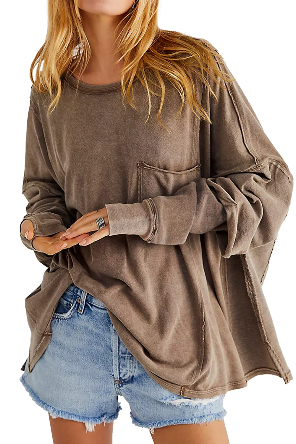 Brown sweatshirt with exposed seams and thumbholes, featuring a drop shoulder design for a relaxed fit.