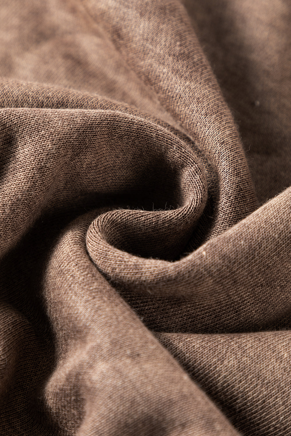 Brown sweatshirt with exposed seams and thumbholes, featuring a drop shoulder design for a relaxed fit.