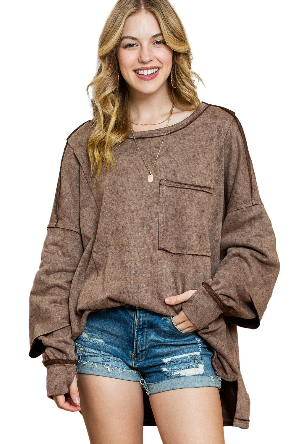 Brown sweatshirt featuring exposed seams, thumbholes, and drop shoulder design, perfect for a relaxed and stylish look.