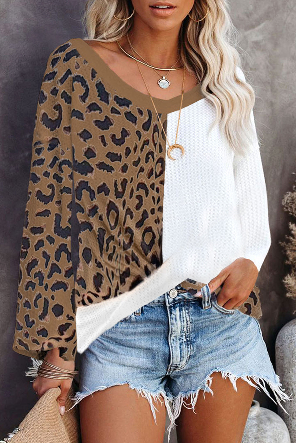 Brown leopard print contrast waffle knit top with twist hem and v-neck design, showcasing a stylish and cozy look.