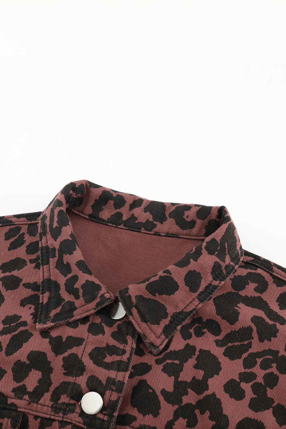 Brown leopard print cropped jacket with raw hem and button closure, featuring flap pockets and a stylish turn-down collar.