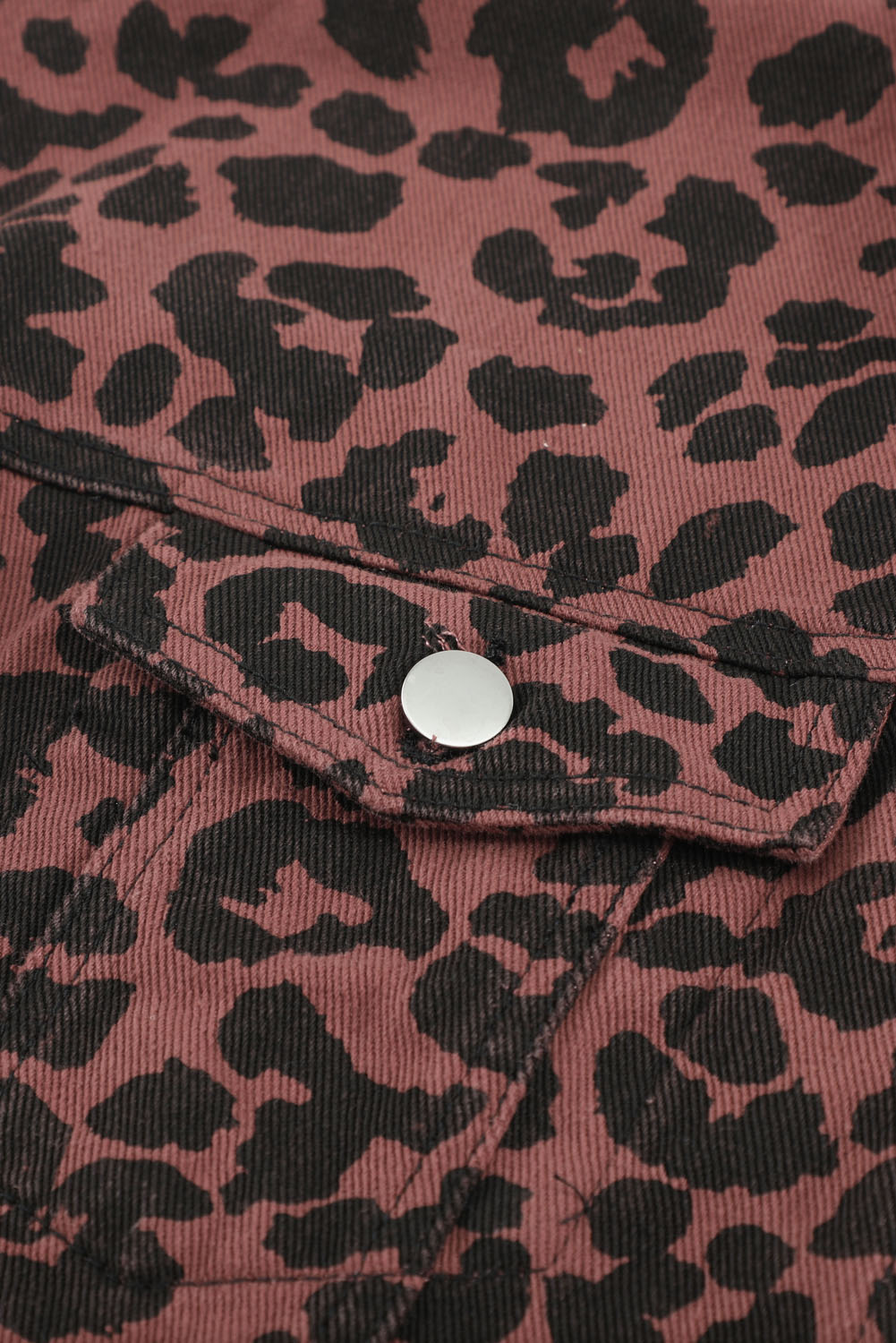 Brown leopard print cropped jacket with raw hem and button closure, featuring flap pockets and a stylish turn-down collar.