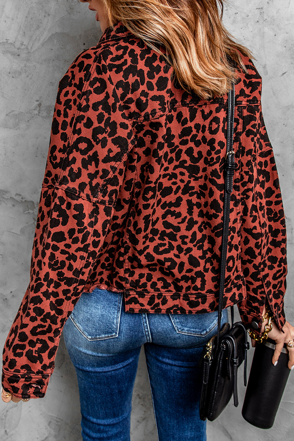 Brown leopard print cropped jacket with raw hem and button closure, featuring flap pockets and a stylish turn-down collar.