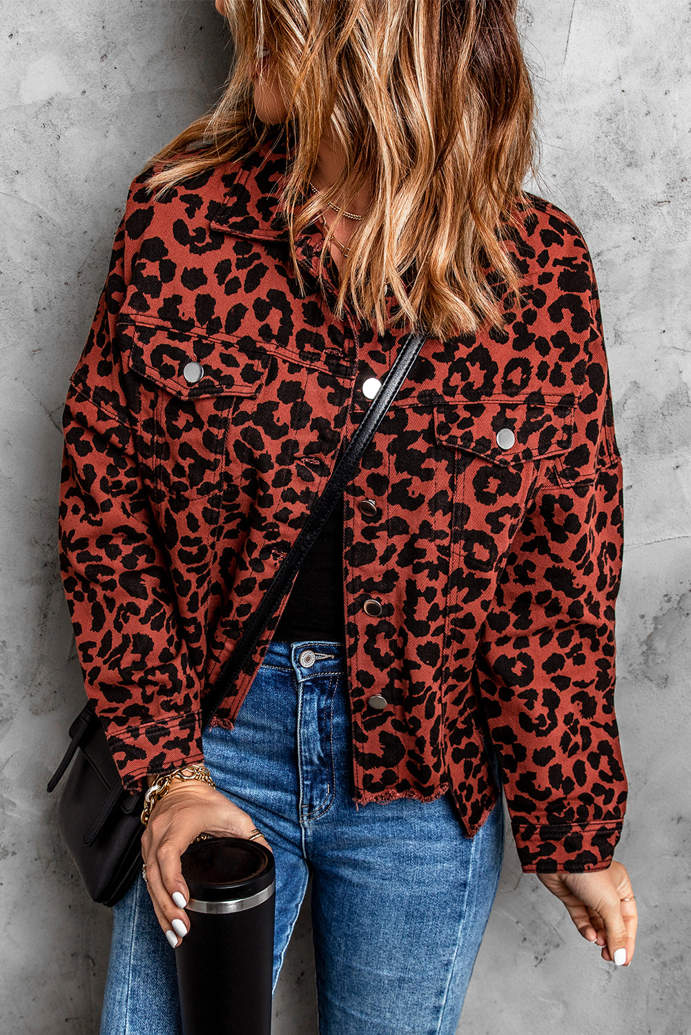 Brown leopard print cropped jacket with raw hem and button closure, featuring flap pockets and a stylish turn-down collar.