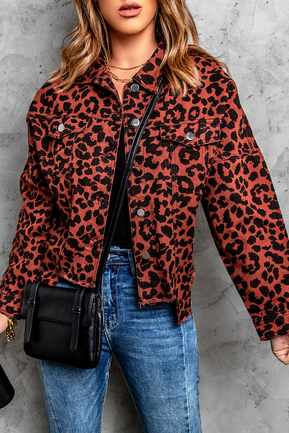 Brown leopard print cropped jacket with raw hem and button closure, featuring flap pockets and a stylish turn-down collar.