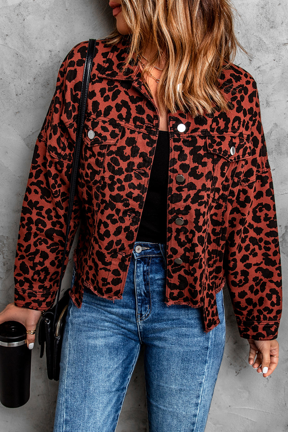 Brown leopard print cropped jacket with raw hem and button closure, featuring flap pockets and a stylish turn-down collar.