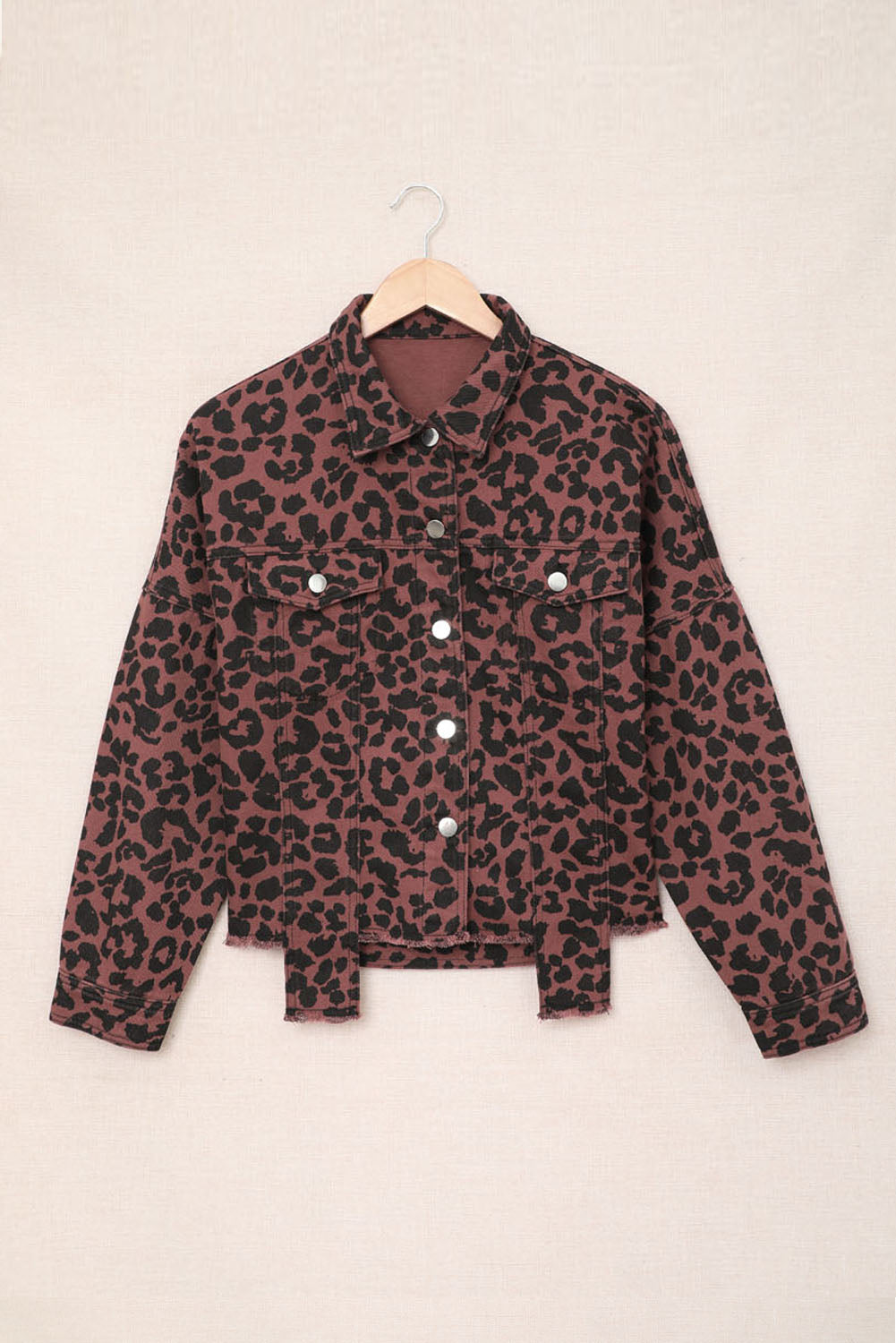 Brown leopard print cropped jacket with raw hem and button closure, featuring flap pockets and a stylish turn-down collar.