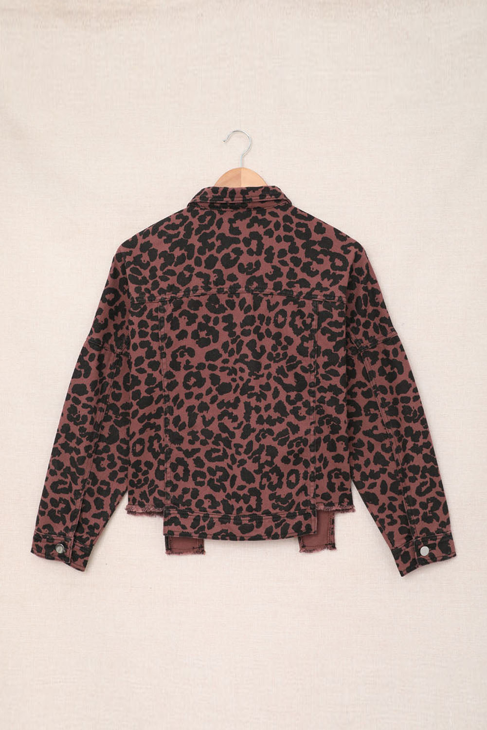 Brown leopard print cropped jacket with raw hem and button closure, featuring flap pockets and a stylish turn-down collar.